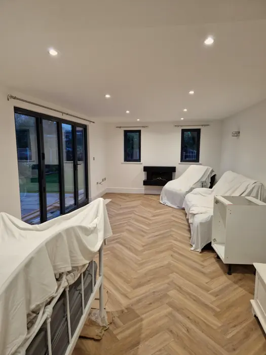 Living area of the extension with bifold doors and herringbone floor