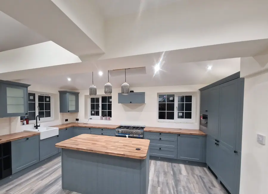 Kitchen extension in Moreton with grey shaker units, a wooden island and a range cooker