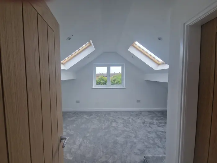 Loft room with two roof windows and an oak door